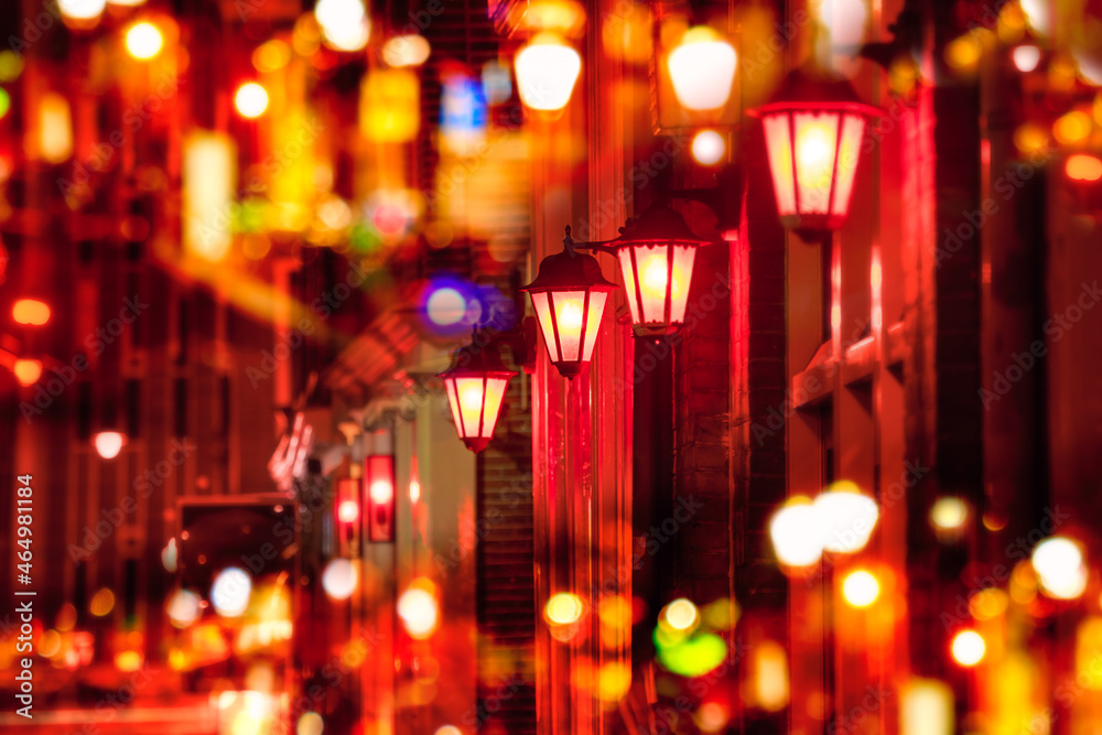 Street lights - Red light district in Amsterdam at night. Background. Selective focus on one lamp and defocus the rest. Amsterdam, Holland, Europe