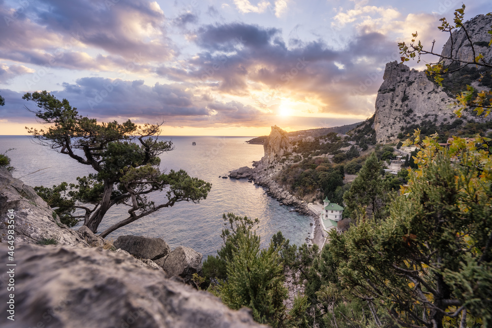 Golden sunset from Panea cliff with mountain cat koshka in background. Simeiz, Crimea. Black Sea