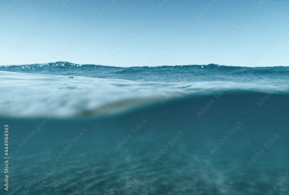 Fototapeta premium Split View Half Over and Under Ocean Surface whit Clear Sky. Background Concept