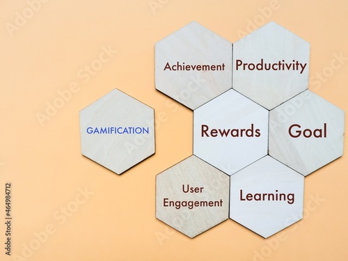 Gamification concept with keywords on wooden hexagon. photo