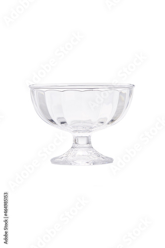 Detailed shot of a glass ice-cream bowl. Kitchen tableware is transparent and has a faceted surface. The ice-cream bowl is isolated on the white background.