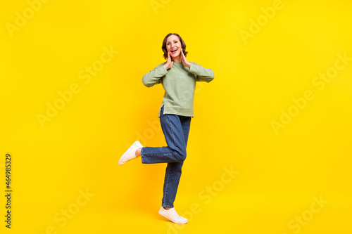 Full length body size view of attractive cheerful woman enjoying having fun good mood isolated over vivid yellow color background
