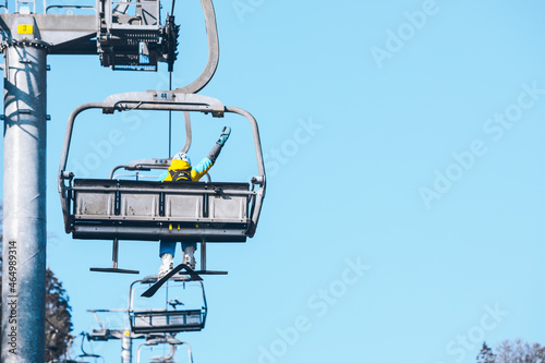 woman going up by chairlift to ski