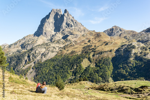 Man laying on grass while enjoying the views after a trekking day at french Pyrenees. Active mountain vacation. 