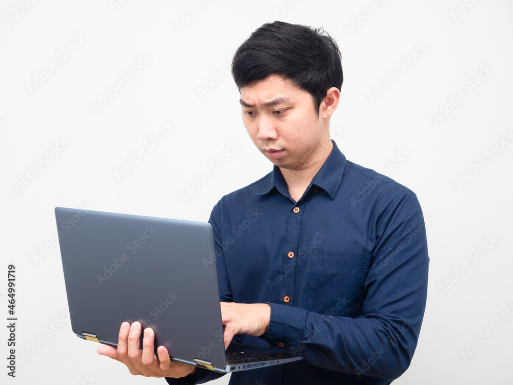 Man using laptop for the job serious emotion Man using laptop for the job serious emotion