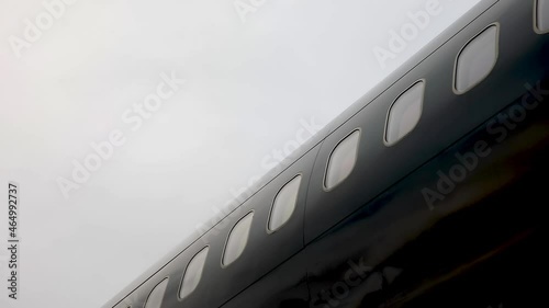 Close up of an airplane windows of black private business jet. High quality FullHD footage