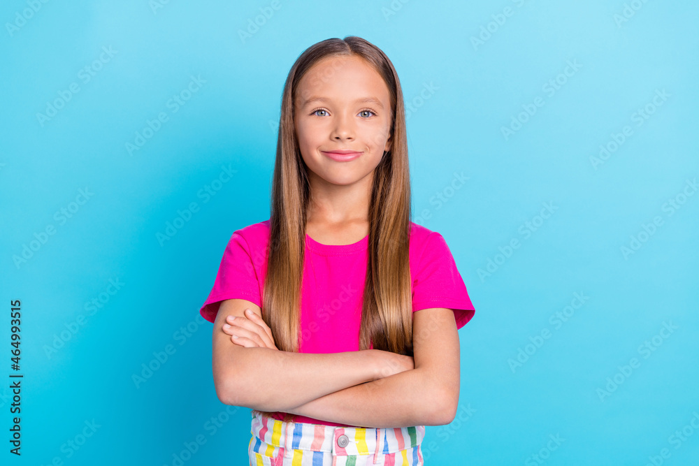 Photo of cheerful young happy confident small girl hold hands crossed isolated on pastel blue color background Photo of cheerful young happy confident small girl hold hands crossed isolated on pastel blue color background