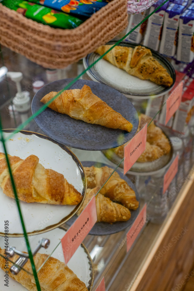 Fresh croissants on display in Russia, sweet with raspberries and almonds and nuts and chocolate and buttercream and not sweet with cheese a large amount Fresh croissants on display in Russia, sweet with raspberries and almonds and nuts and chocolate and buttercream and not sweet with cheese a large amount