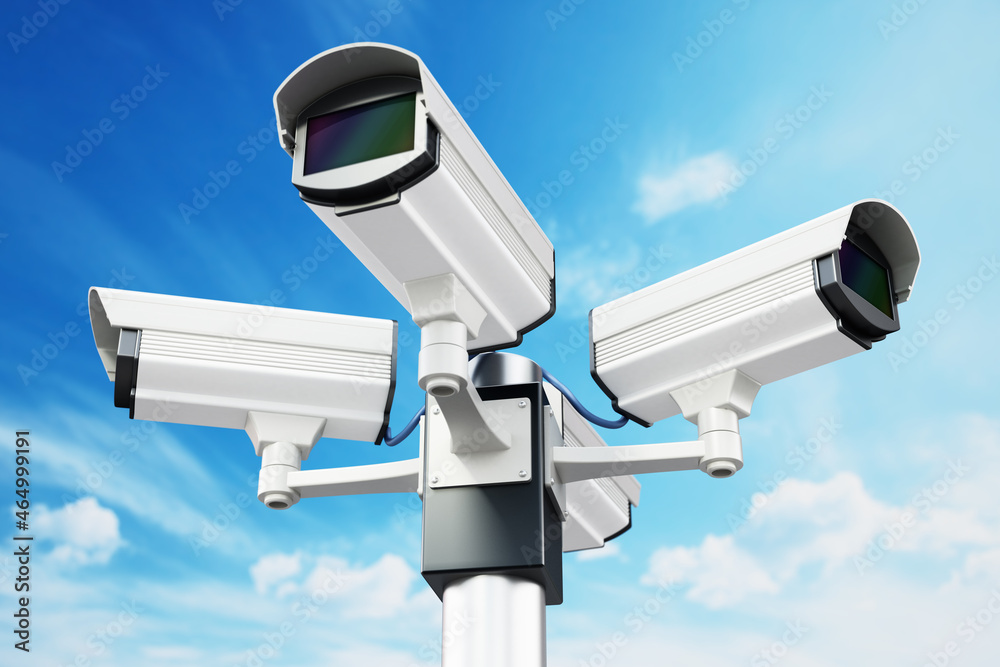 Security cameras on the pole on blue sky background. 3D illustration