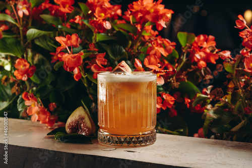 Whiskey sour cocktail with fig in old fashioned glass 