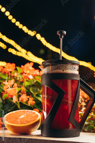 Red french press tea with grapefruit photo