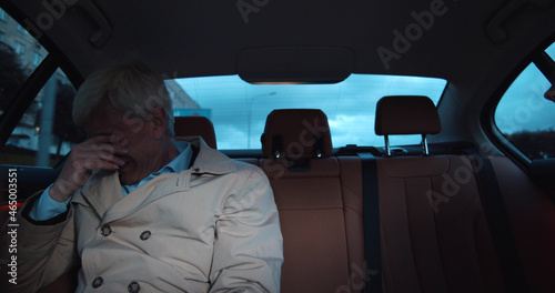 Stressed sad aged man crying in backseat of taxi © nimito