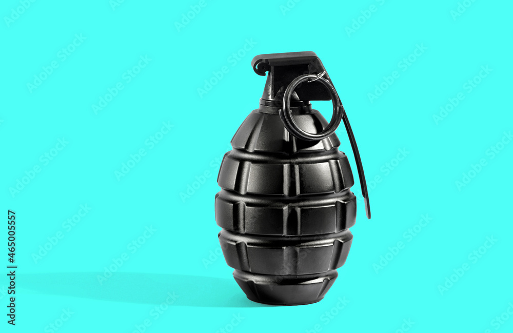 Fototapeta premium Single grenade with shadow on cyan background