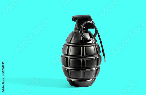 Single grenade with shadow on cyan background