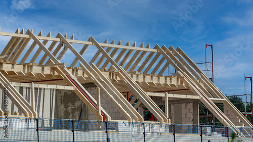 Wooden roof trusses are created on the new construction of a house