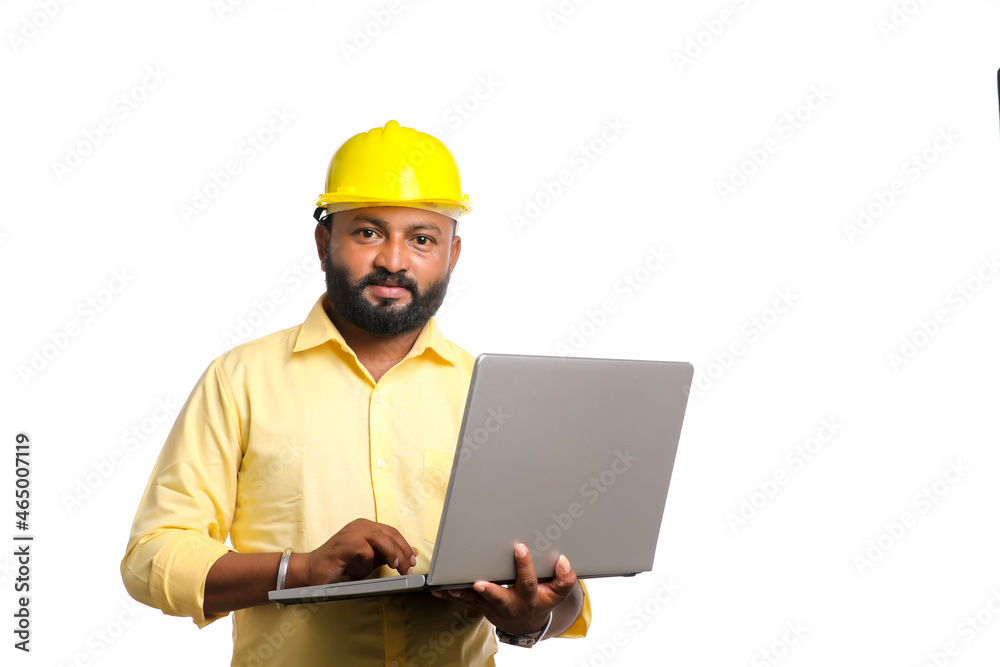 young Indian engineer in uniform and using laptop on white background. young Indian engineer in uniform and using laptop on white background.