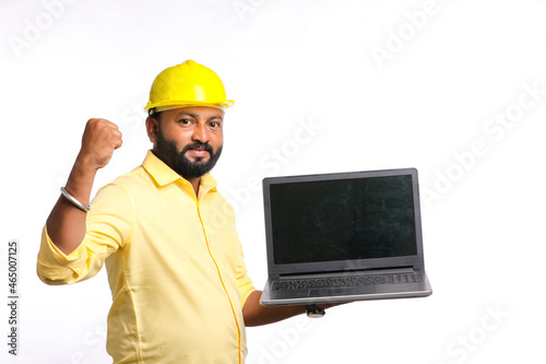 Indian engineer showing laptop empty screen on white background.