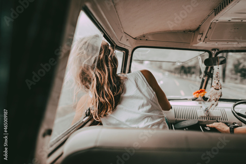 Boho woman road trip portrait in a minivan, travel HD photo