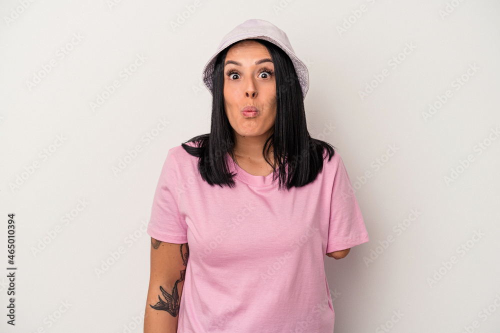 Young caucasian woman with one arm isolated on white background shrugs shoulders and open eyes confused. Young caucasian woman with one arm isolated on white background shrugs shoulders and open eyes confused.