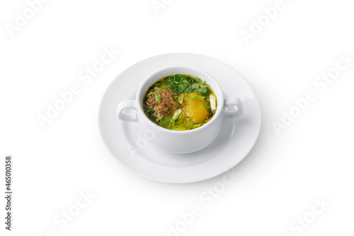 Chicken soup with potato and herbs isolated on white background