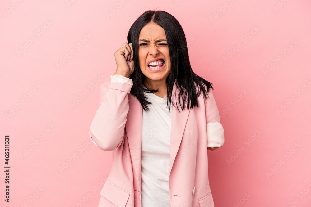 Young caucasian woman with one arm isolated on pink background covering ears with hands. Young caucasian woman with one arm isolated on pink background covering ears with hands.