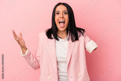 Young caucasian woman with one arm isolated on pink background receiving a pleasant surprise, excited and raising hands.