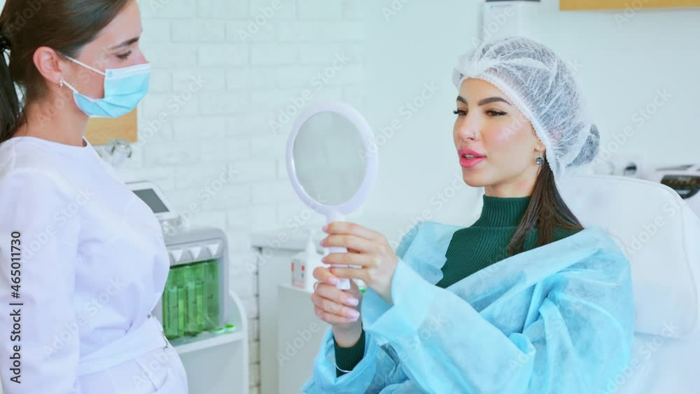 Cosmetologist doctor asks a woman about what she wants to change Cosmetologist doctor asks a woman about what she wants to change