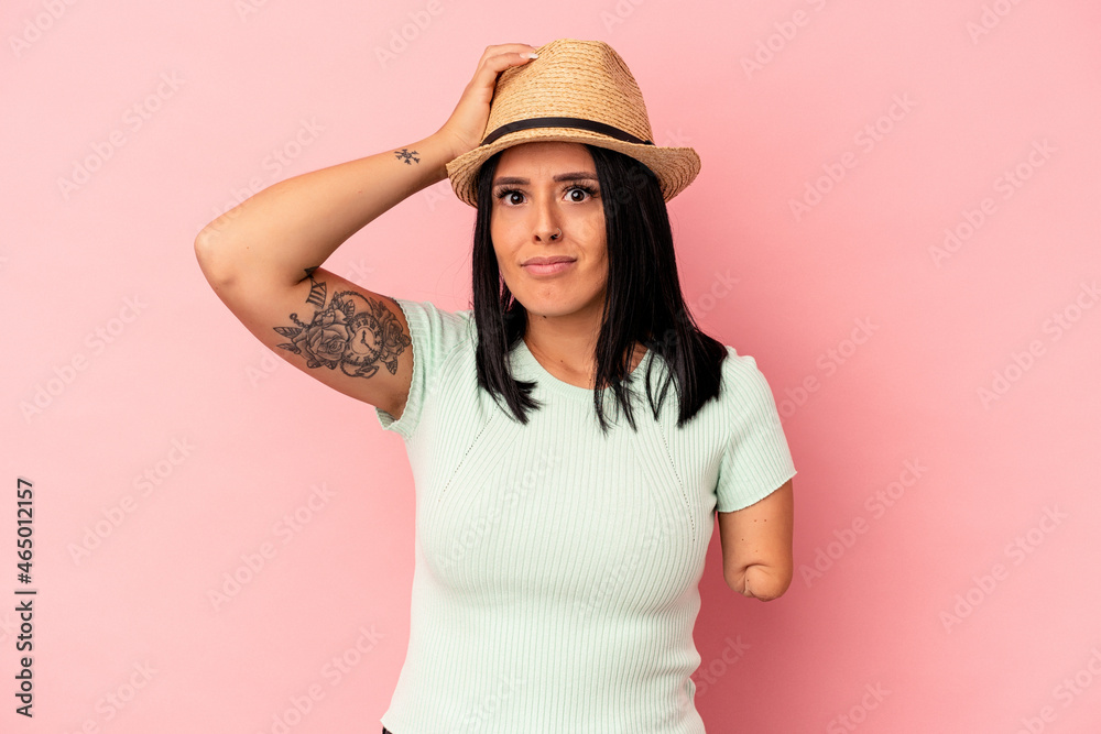 Young caucasian woman with one arm wearing a summer hat isolated on pink background being shocked, she has remembered important meeting.