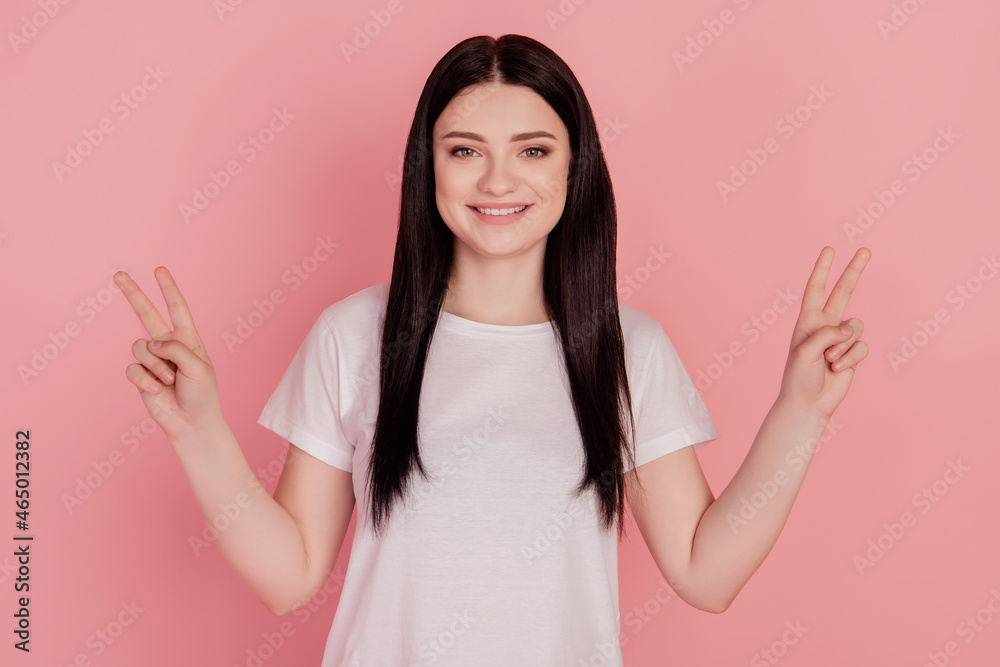 Photo of positive friendly lady show v-sign isolated on pink color background