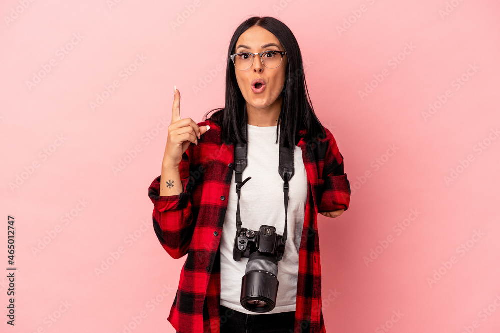 Young caucasian photography woman with one arm isolated on pink background having some great idea, concept of creativity. Young caucasian photography woman with one arm isolated on pink background having some great idea, concept of creativity.