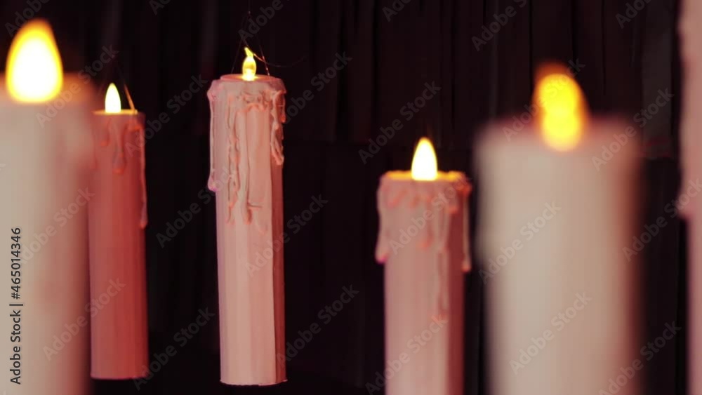 Floating candles with black backdrop (steadycam). Unfocused and focused.