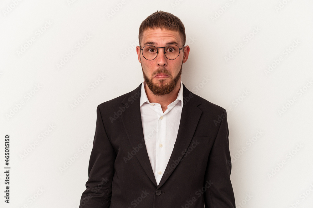 Young business caucasian man isolated on white background shrugs shoulders and open eyes confused. Young business caucasian man isolated on white background shrugs shoulders and open eyes confused.