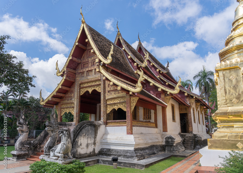 Scenic landscape side view of historic Lanna style viharn Lai Kham inside compound of famous landmark Wat Phra Singh buddhist temple, Chiang Mai, Thailand