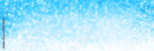 Christmas blue snow Background. Holiday Abstract Glitter Defocused Background With Blinking Stars.Holiday glowing backdrop.Banner