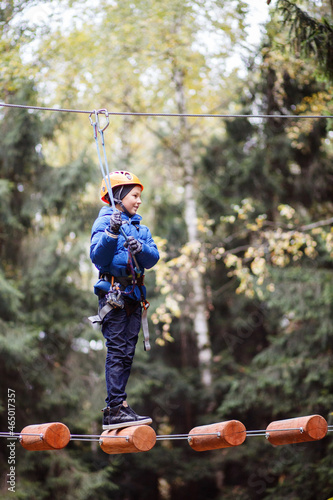 Little boy enjoy riding on ice slide on snowy day. Baby having fun during blizzard. Outdoor winter activities for family with kids.