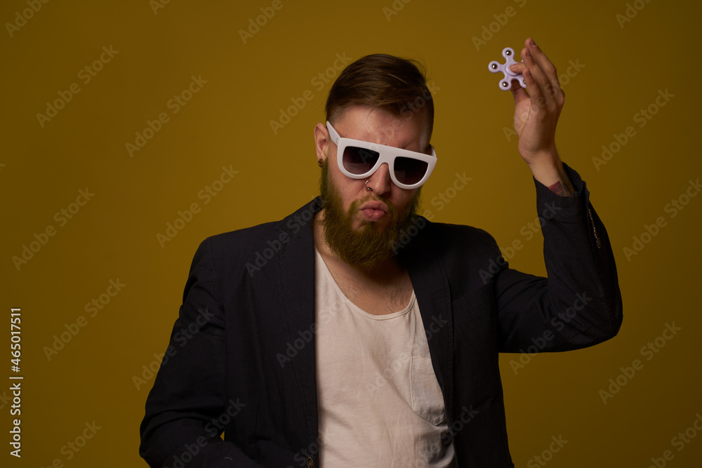 man wearing sunglasses spinner in hands fashion posing black jacket