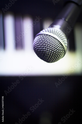 Microphone over piano keys in dim light