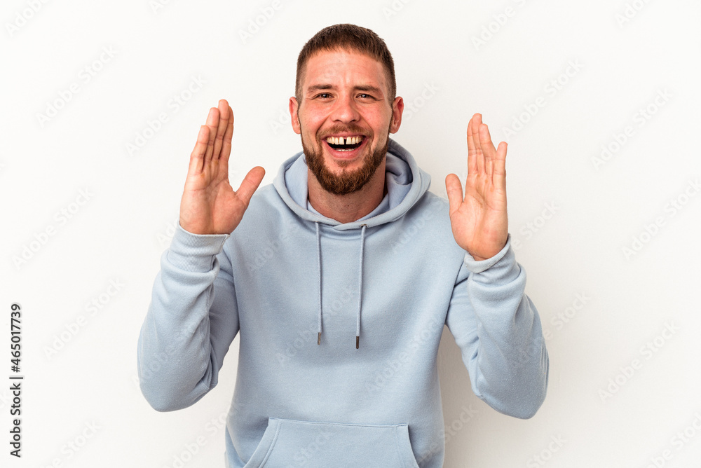 Young caucasian man with diastema isolated on white background laughs out loudly keeping hand on chest.