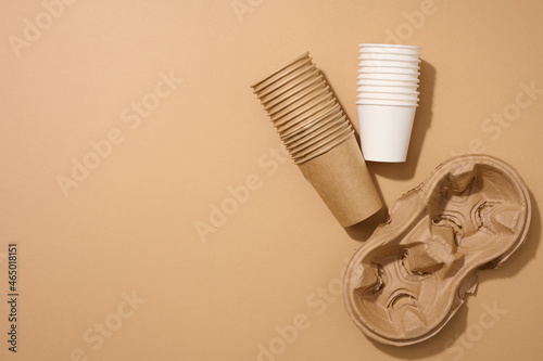 paper brown disposable cardboard cup and holder on brown background