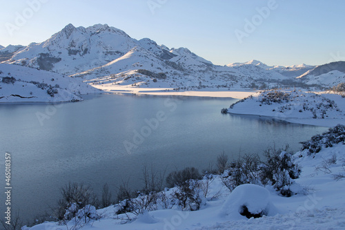 A winter image of a sunset on the banks of the Riaño reservoir in the Cantabrian mountains, León, Spain