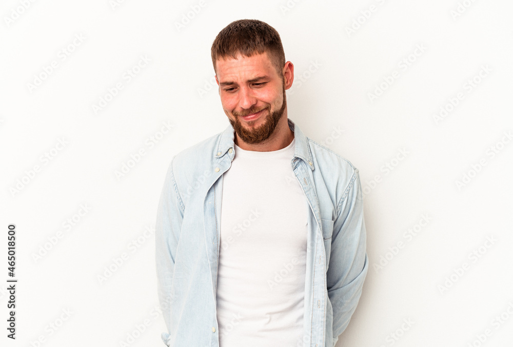 Young caucasian man with diastema isolated on white background laughs and closes eyes, feels relaxed and happy. Young caucasian man with diastema isolated on white background laughs and closes eyes, feels relaxed and happy.