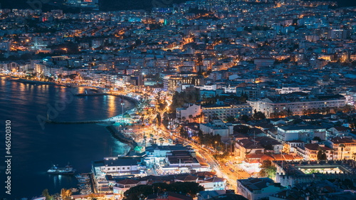 Kusadasi, Aydin Province, Turkey. Waterfront And Kusadasi Cityscape In Summer Evening. Night Scenic View Of Kusadasi Skyline At Aegean Coast, Turkey. 4K