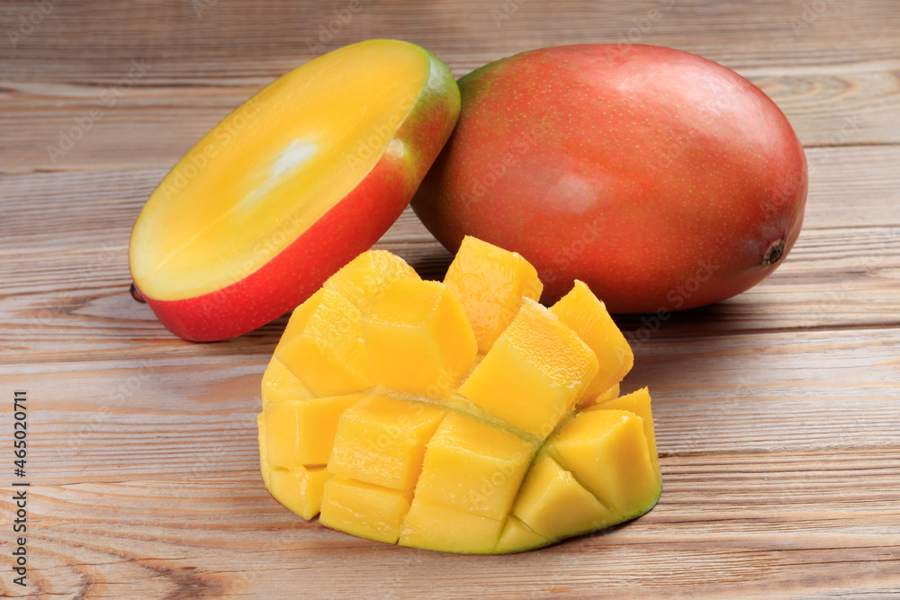 Close-up view of Sliced mango on a rustic wooden table. Soft focus.