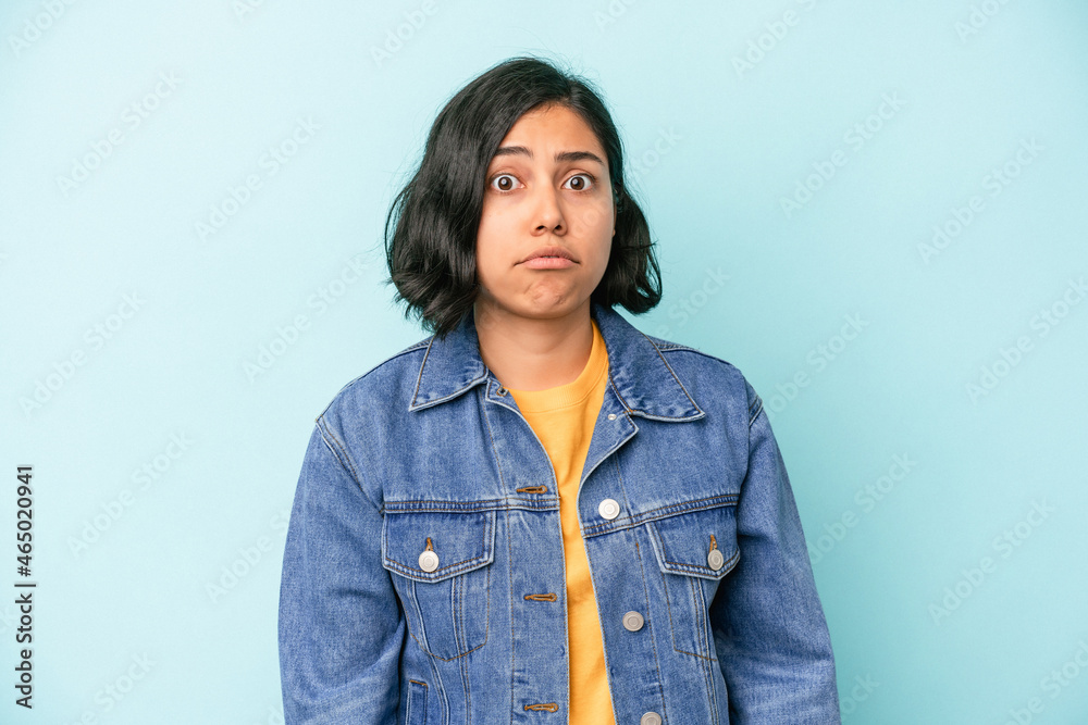 Young latin woman isolated on blue background sad, serious face, feeling miserable and displeased. Young latin woman isolated on blue background sad, serious face, feeling miserable and displeased.