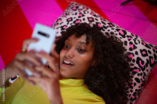 Overhead shot of young adult female looking at a smartphone photo