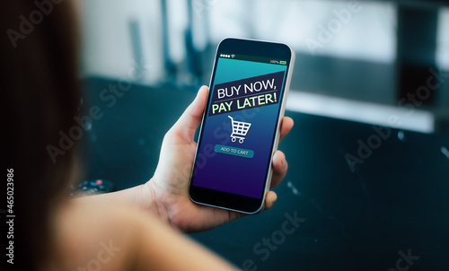 BNPL Buy now pay later online shopping concept.Hands holding mobile phone