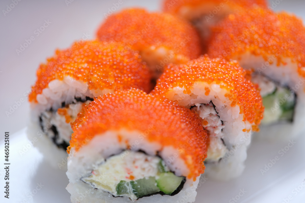 Bright tasty sushi with caviar in a white surface Bright tasty sushi with caviar in a white surface