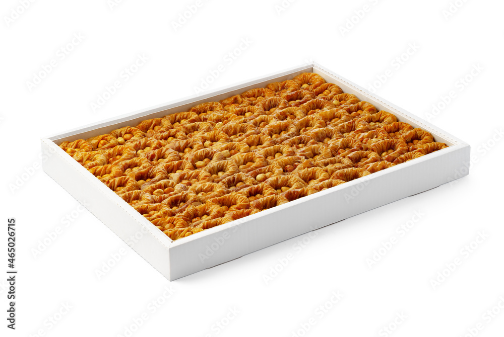 Turkish baklava dessert in a white box isolated on white. Turkish baklava dessert in a white box isolated on white.