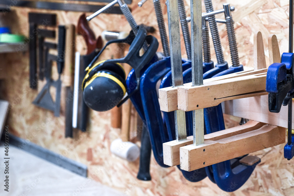 Work tools A selection of carpentry tools hang in a workshop for woodwork