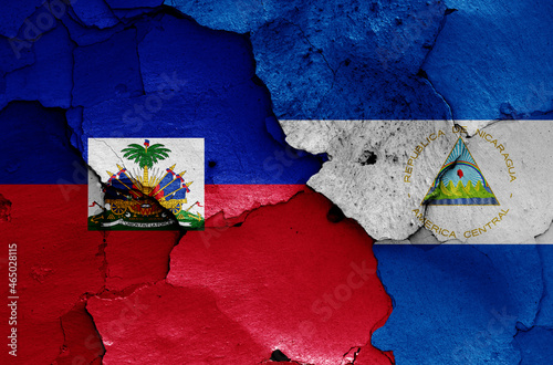 flags of Haiti and Nicaragua painted on cracked wall